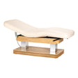Cream-colored SPA lounger Sillon Comfort with light brown base, used as beauty salon furniture for client relaxation.