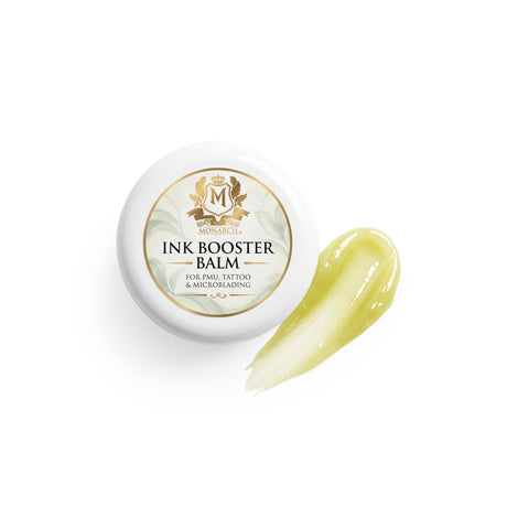 Skin Monarch Ink Booster Balm 30ml, coperchio accanto a una striscia di balsamo giallo lucido